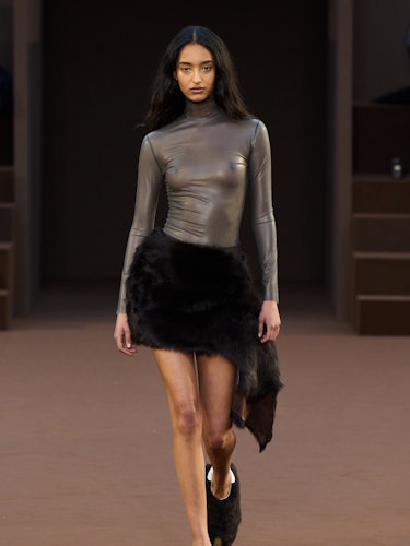 a silver sheer turtleneck and black furry skirt from Loewe
